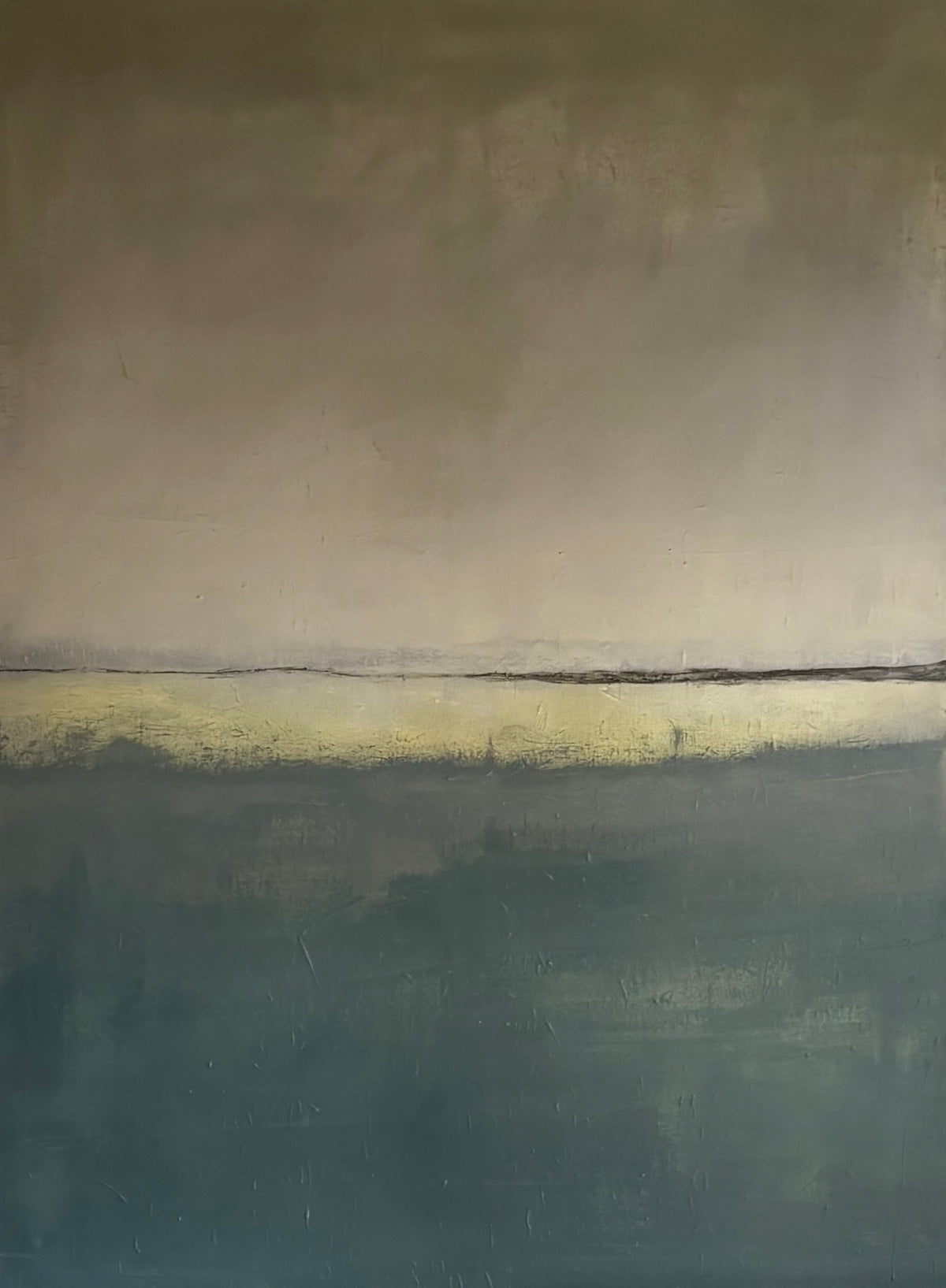 An abstract landscape painting featuring a horizontal horizon line. The upper half depicts a muted, warm grayish-beige sky, while the lower half is a dark teal-blue field with a soft yellow band near the horizon.